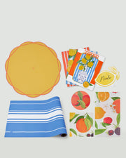 Summer Table Essentials bundle with striped paper runner, colourful scalloped placemats, citrus napkins, coasters, name cards and greaseproof paper.