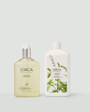 White Tea & Wild Mint Hand Wash and matching refill bottle on a pale background.