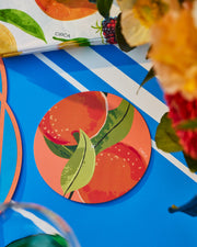 Round Summer paper coasters with a colourful fruit and green leaf print.