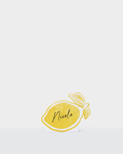 Summer paper name cards with a yellow lemon and illustrated bow design.