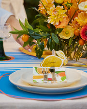 Summer paper name cards with a yellow lemon and illustrated bow design.