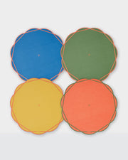 Scalloped Summer paper placemats in blue, green, yellow and coral with contrasting outlines.