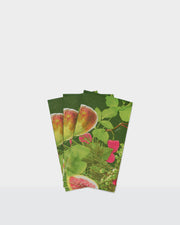Festive paper dinner napkins with figs, green leaves and pink floral details.