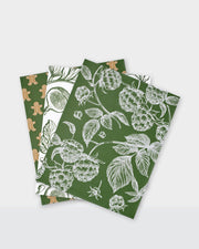Festive greaseproof paper featuring green botanical prints and gingerbread designs.
