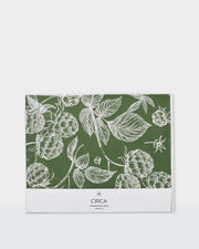 Festive greaseproof paper featuring green botanical prints and gingerbread designs.