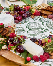 Festive greaseproof paper featuring green botanical prints and gingerbread designs.