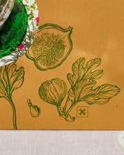 Festive paper table runner in warm brown with green botanical borders.