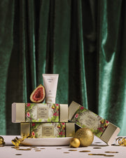 Mango & Papaya Hand Cream and botanical bonbon gift boxes styled with figs and gold Christmas decorations.