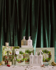 Oceanique Room & Linen Spray and ceramic stones with other Christmas gifts in a green velvet festive display.