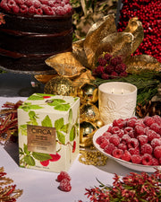 Raspberry & Rhubarb candle and botanical gift box styled with raspberry desserts and gold Christmas decorations.