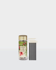 White Fig & Cedar Christmas Tree Scent Stems with hooks beside their botanical storage tube.