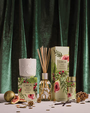 White Fig & Cedar candle, fragrance diffuser and Tree Scent Stems with botanical packaging in a festive setting.